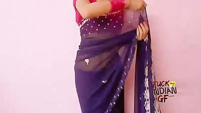 Young indian wife teaching how to wear saree